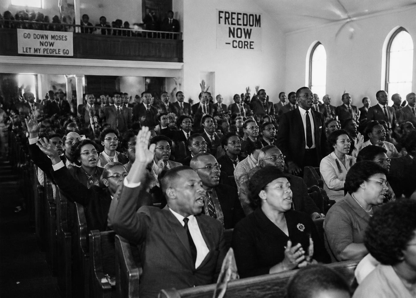 Archival scene of a 1960s civil rights mass meeting inside a Birmingham church